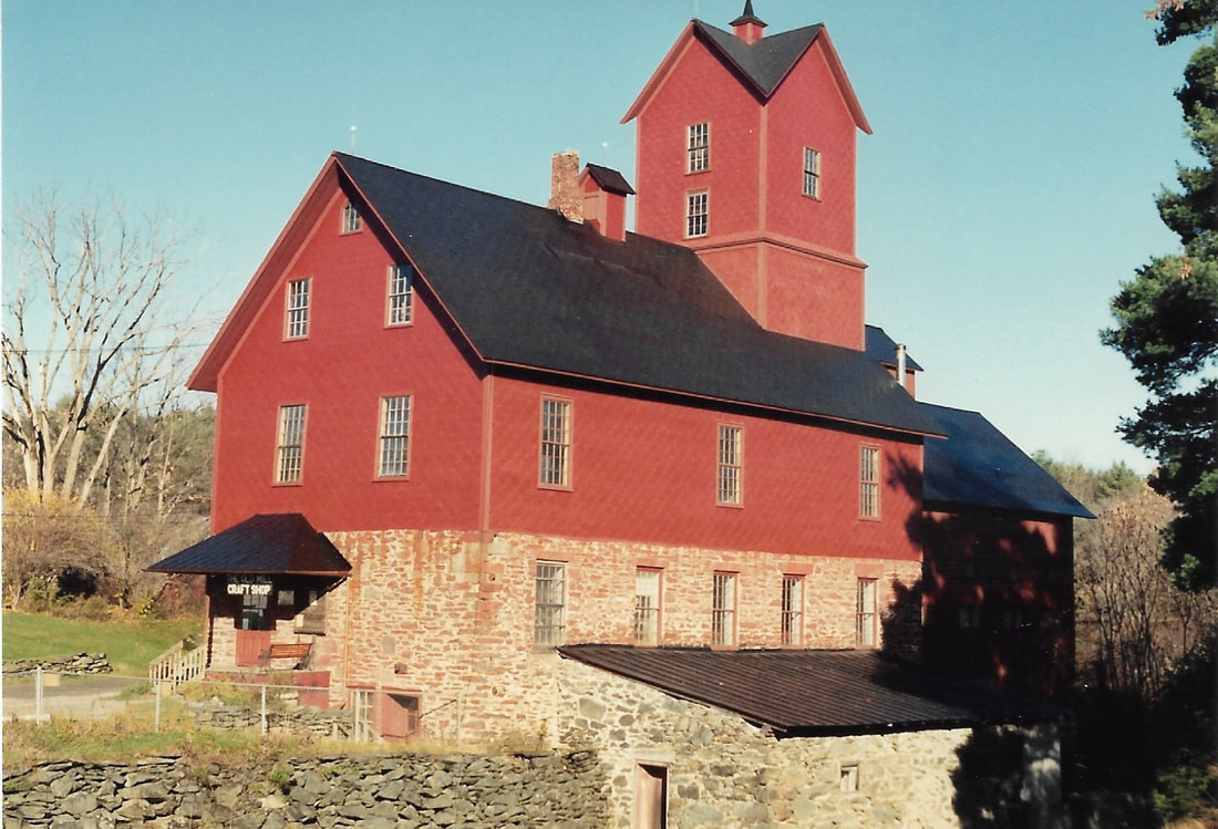 Picture 17 – This photo shows the mill after all of the roof had been replaced, and that along with the metal covered portion of the side walls had been painted.  November 3, 1994