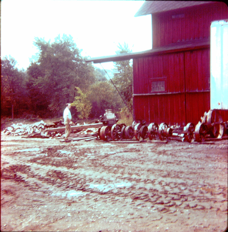 Picture 9 – The shafting that powered the milling machinery acquired from the Pleasant Valley Roller Mills after being unloaded in the mill parking lot – September 29, 1974.  Later most of this was given away by the historical society for scrap iron.