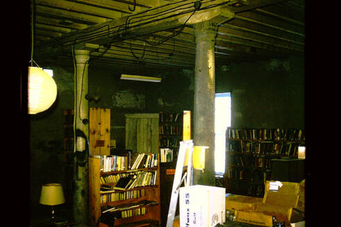 Picture 19 – Brown’s River Library, sometimes known as the Jericho Village Library and which for years was sponsored by the Brown’s River Study Club, when it was in the middle room of the mill.  It was in this space from 1973 to 1976.  The photo is from March 21, 1974.  This was known as the middle room, as at that time the original wall which divided the first floor of the main building into two rooms was still in place.  That was later removed, along with the stairs to the second floor, when the new flooring was installed on the first floor.