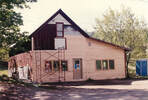Picture 24 – The barn during renovations, May, 1989.  The garage doors were removed, and new siding and windows installed.